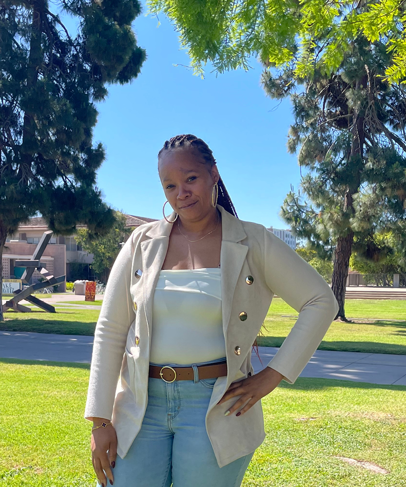 This is a headshot of Guardian Scholar Intern, Lakeysha. Lakeysha wears a tan blazer and jeans.