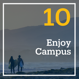 This is a photo of students walking with their surfboards towards the sunset. The embedded text emphasizes, "Enjoy Campus." This is flashcard image 10 out of 10.