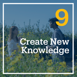 This is a photo of two students talking outdoors in a field of flowers. The embedded text emphasizes, "Create New Knowledge." This is flashcard image 9 out of 10.