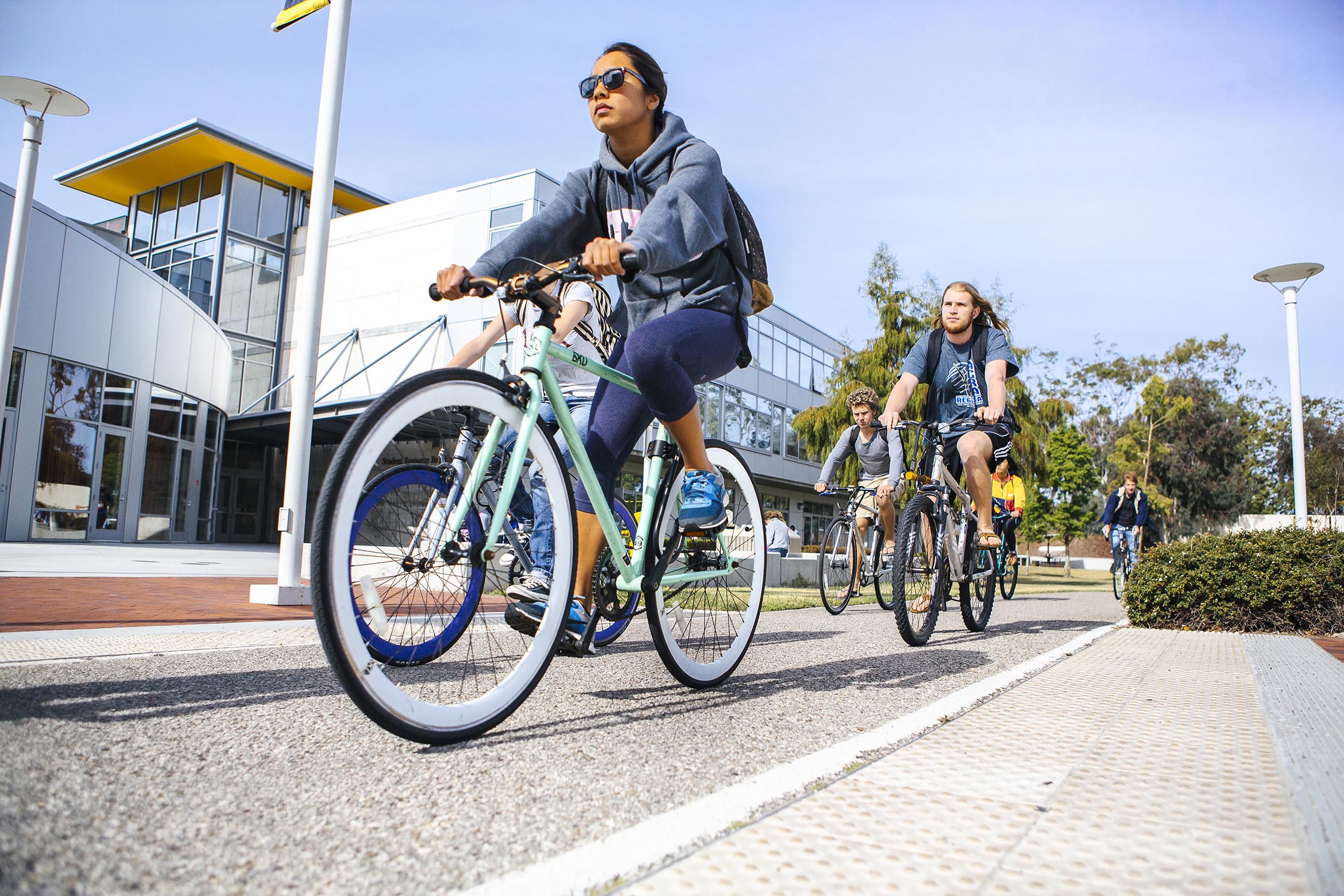 This is a student biking on a UCSB bike path.